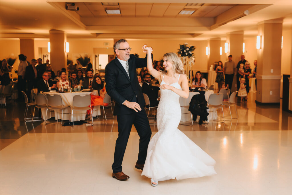 Johanna dancing with her dad at her wedding reception in her bustled dress