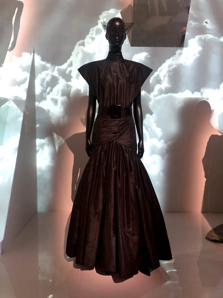 black Dior gown with cloud projections in background